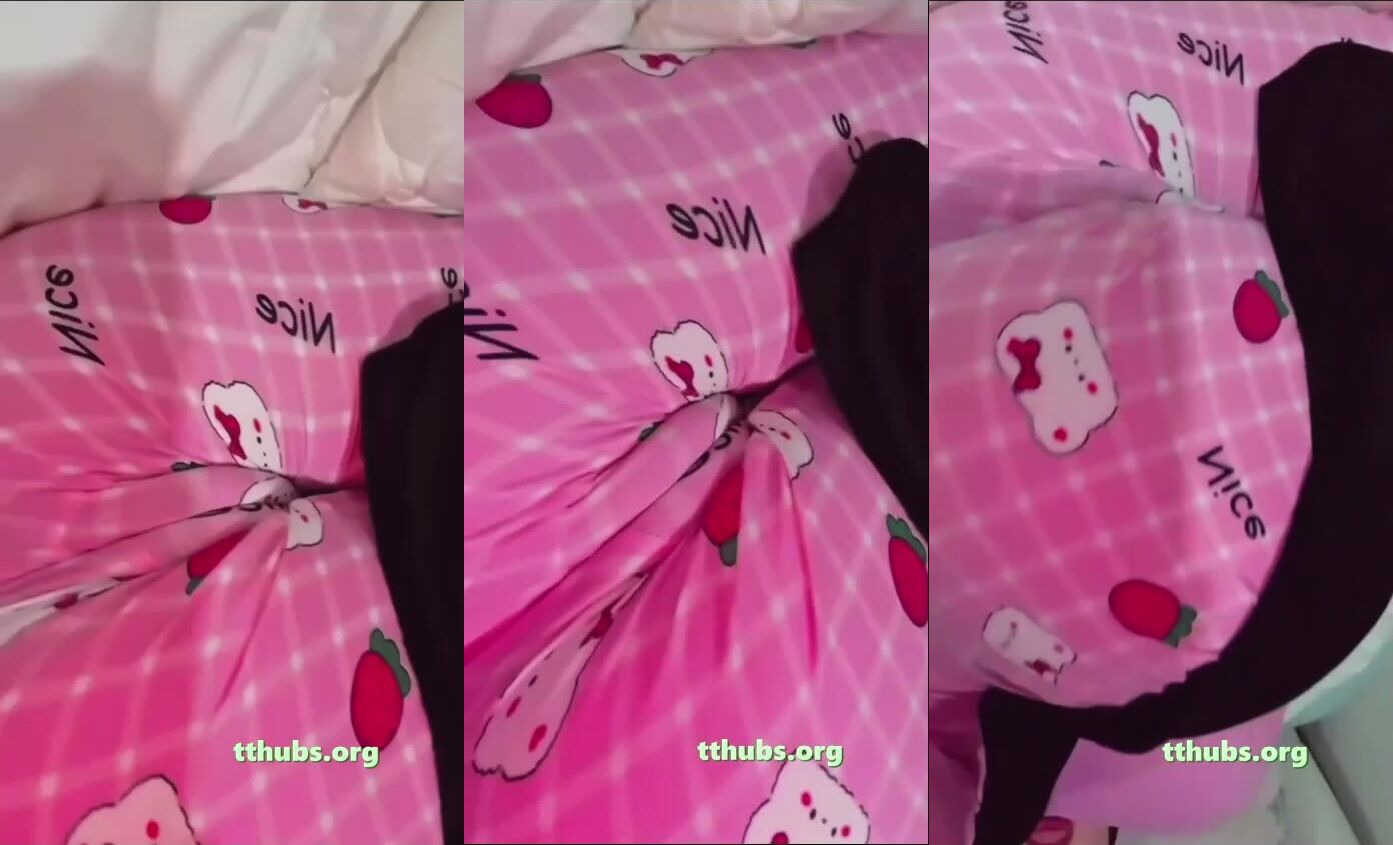 pembe pijamalı kadın yatakta yüzüstü yatıp kalçasını kıvırıyor