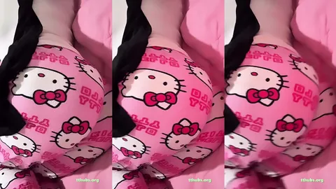 Yatakta pembe desenli iç çamaşır giyen uzun saçlı kadın poz veriyor